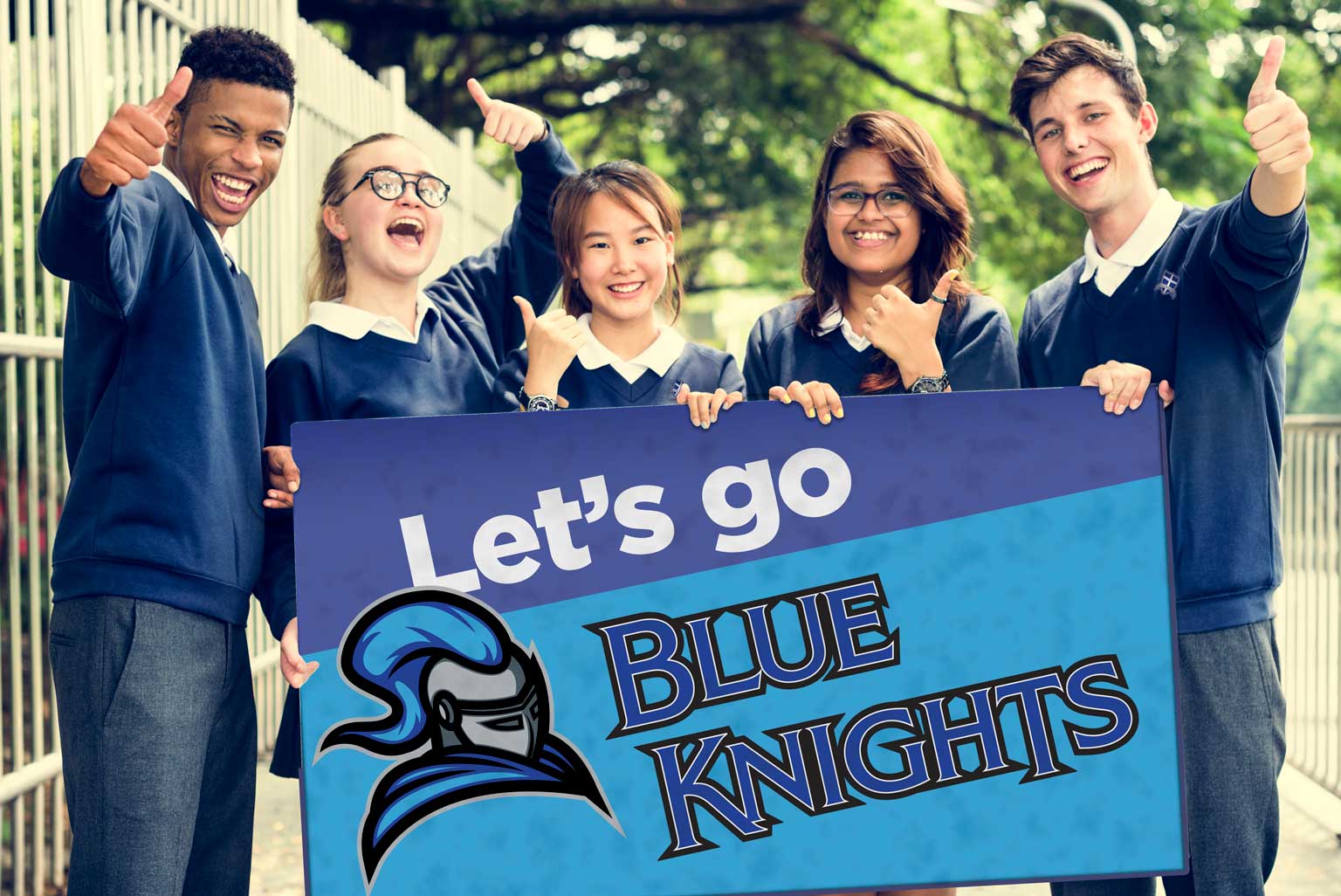 Five middle school students give thumbs-up while posing outdoors with a sign that reads, "Let's Go Blue Knights."