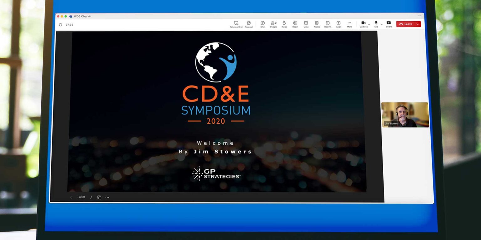 Laptop screen displays title slide that says, "CD&E Symposium 2020," Welcome by Jim Stowers.